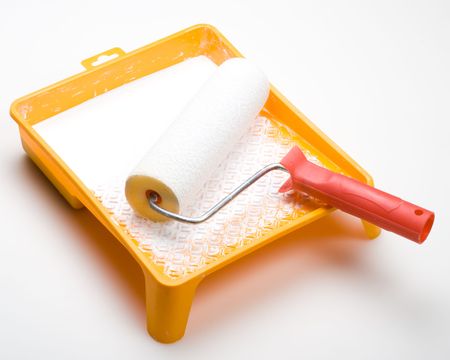 Paint-roller and tray with paint on a white backgroundの写真素材