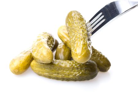 Crackling pickled gherkins on a plug on a white backgroundの写真素材