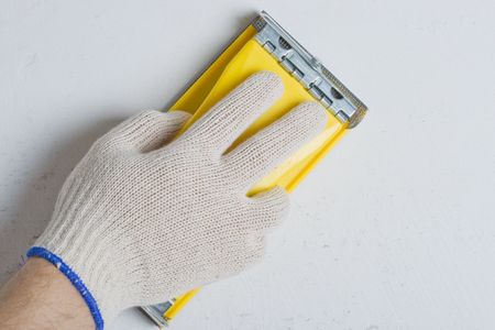 Apartment repair. Processing of a wall by an sandpaper.の写真素材