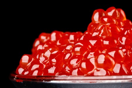 Dish with red caviar on a black backgroundの写真素材