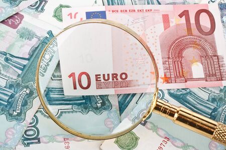 Money and magnifier. Exchange rate financial concept.の写真素材