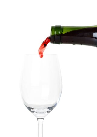 Red wine poured in a glass isolated on a white backgroundの写真素材
