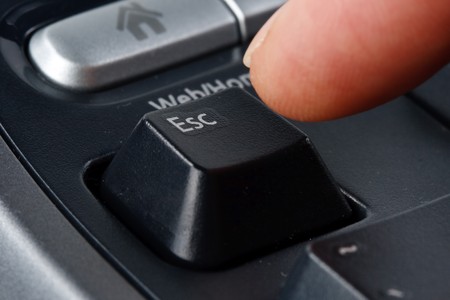 Modern black ergonomic computer keyboard. Close up. Focus on ESC button.