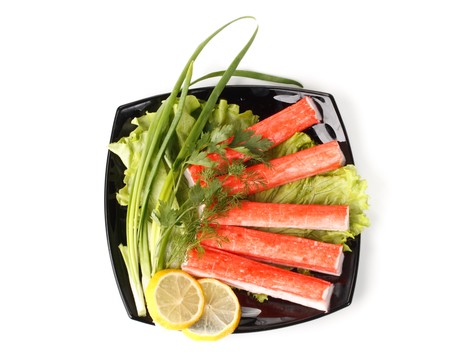 Crabmeat sticks with vegetables on a white backgroundの写真素材