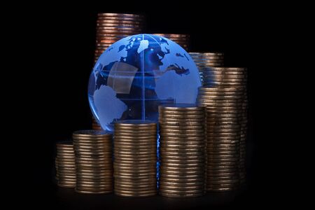 Diagram of growth from coins and blue glass globe. Global business concept.の写真素材