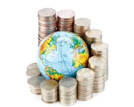 Diagram of growth from coins and globe on a white background. Global business concept.の写真素材
