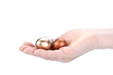 Gold, silver and bronze eggs in a hand. Concept for success.