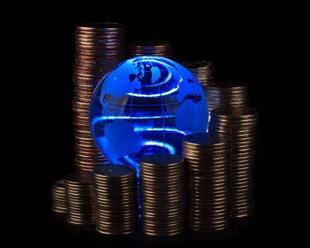 Diagram of growth from coins and blue glass globe. Global business concept.の写真素材