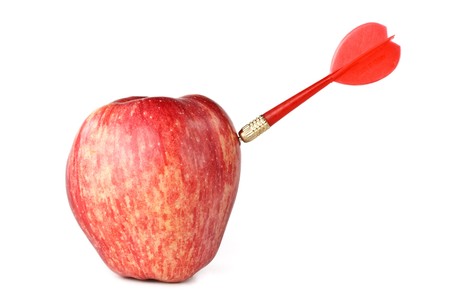 Dart and apple on a white background.  Concept for success. Close up.の写真素材