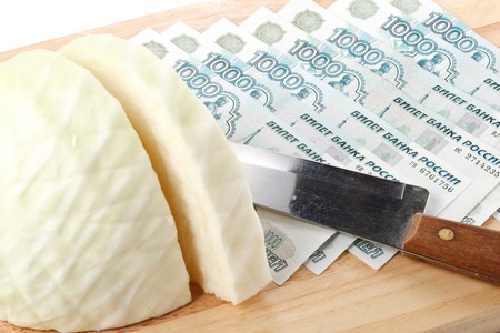 Chopping board, cash, knife and cabbage. Money concept.の写真素材