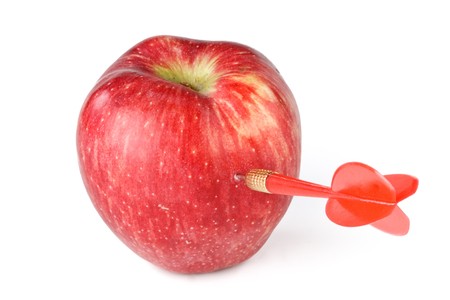 Dart and apple on a white background.  Concept for success. Close up.の写真素材