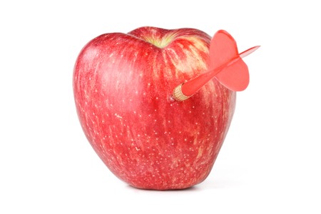 Dart and apple on a white background.  Concept for success. Close up.の写真素材