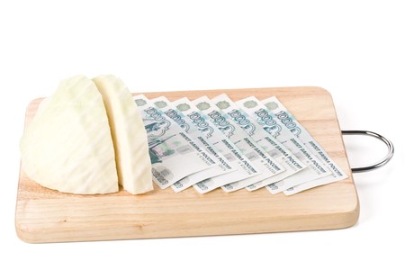 Chopping board, cash, knife and cabbage. Money concept.の写真素材