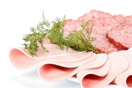 The sausage cut by slices on a dish.の写真素材