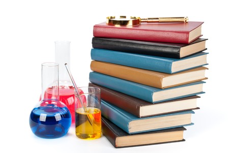 Staircase from books , flasks and a magnifier on a white backgroundの写真素材