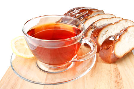 Fresh bun and cup of tea on a white backgroundの写真素材