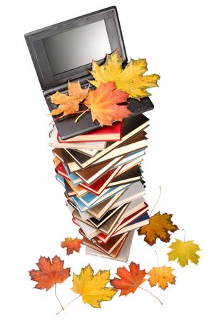 Pile of books, notebook and autumn leaves on a white background.の写真素材
