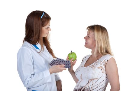 Pregnant female and doctor on a white backgroundの写真素材
