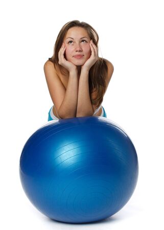 Young  beautiful woman with gymnastic ball on a white background.の写真素材