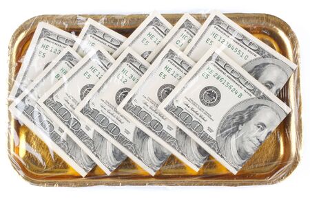One hundred dollars banknotes on a trayの写真素材