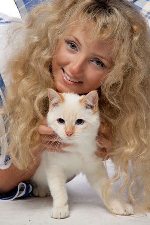 Portrait of the beautiful girl with a kitten on a white background.の写真素材