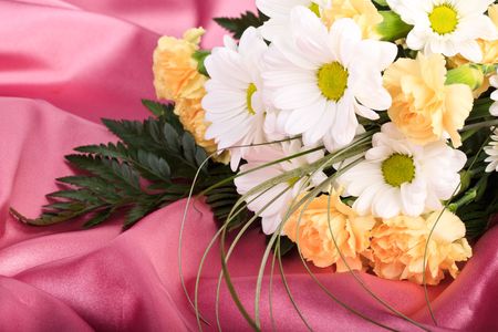Beautiful bouquet of flowers on background of pink sateenの写真素材