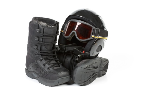 Boots for snowboarding and a protective helmet on a white background.