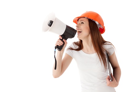 Young female construction superintendent with megaphone and clipboard on a white background.の写真素材