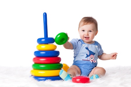 Sweet small baby with toy on a white background.