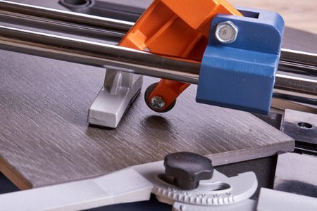 Manual cutter  and ceramic tiles for floor. Home repair.の写真素材
