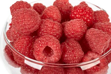 Fresh raspberry in a vase over white background