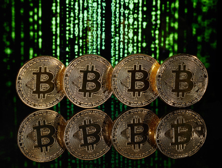 Cryptocurrency in front of green matrix background.