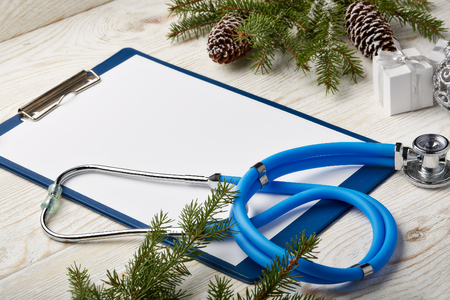 Stethoscope, blank clipboard and Christmas decorations. Medical concept. Greeting card. New Year and Christmas.の写真素材