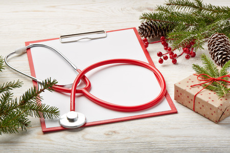 Stethoscope, blank clipboard and Christmas decorations. Medical concept. Greeting card. New Year and Christmas.の写真素材