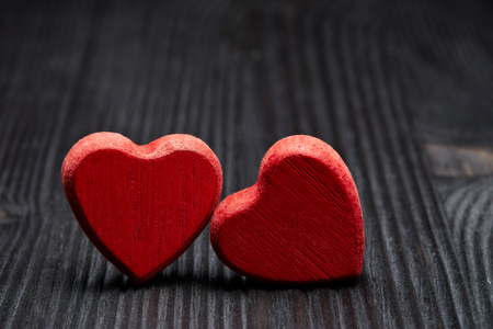 Two decorative hearts on a dark wooden background. Valentine's Day card. Design element for romantic greeting card, wedding invitation,の写真素材