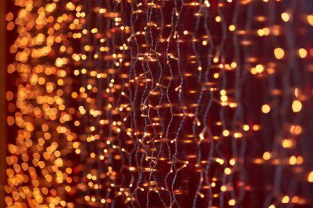 Festive background with LED lights garland. Christmas and New Year background. Blurred bokeh from the lights of a garland.の写真素材