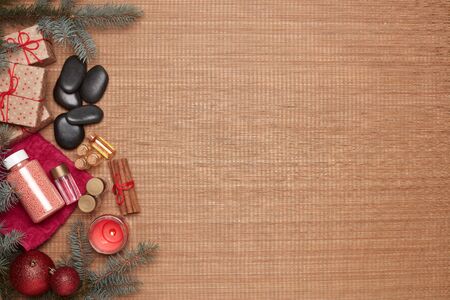 Spa still life with  toiletry, creams, gift boxes and Christmas ornaments on bamboo mat background. Top view with copy space. New Year and Christmas Healthy lifestyle, body care, Spa treatmentの写真素材