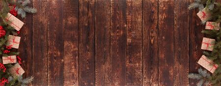 Festive wooden vintage background with fir tree branches and gift boxes Top view with copy space....