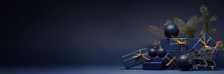 Shopping trolley, gift boxes, fir branch and Christmas ornaments on dark blue background with copy...