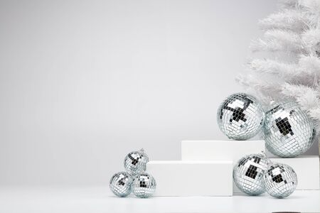 Festive composition with white geometrical figures, Christmas fir tree and mirorr balls isolated on white background with copy space. For design of advertising,  web design. Christmas and New Yearの写真素材