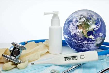 COVID-19. World globe with stethoscope, medical masks, sanitizer, thermometer on white background....