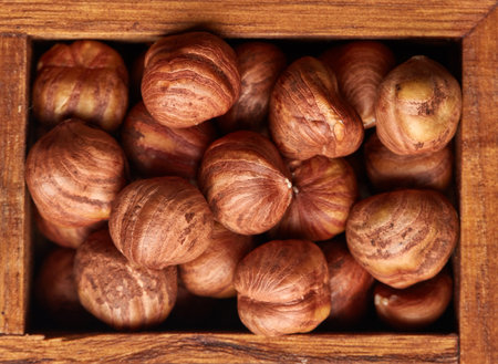 Hazelnuts in wooden box on brown wood background. Top view. Filbert. Cobnut. Healthy food. Vegetarian nutritionの写真素材