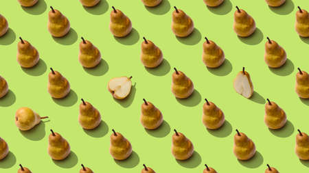 Food pattern background. Bright fruit pattern of fresh pears whole and sliced on green background. Top viewの写真素材