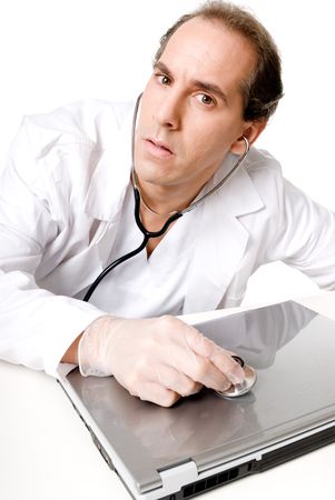 Doctor with stethoscope fixing laptop, good technical support symbol. の写真素材