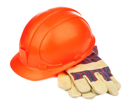 A construction hat and heavy duty gloves isolated over whiteの写真素材