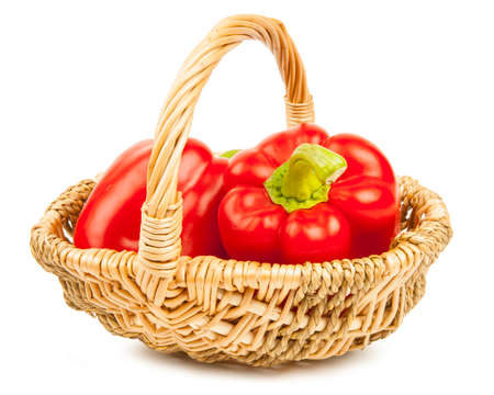 Red pepper in basket on white backgroundの写真素材