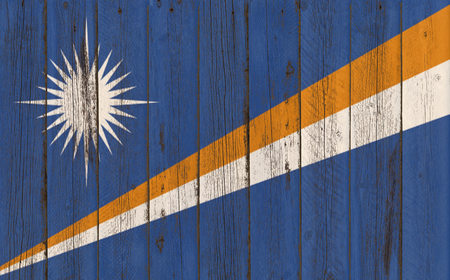 Flag of Marshall Islands painted on wooden frameの写真素材