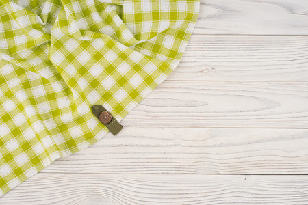 The green cloth on a white wooden table. Top view.の写真素材
