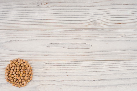 Chickpeas on old wooden table. Abstract background, empty template. Top view.の写真素材