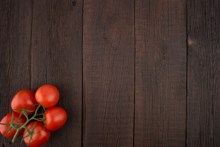 Tomatoes on old wooden table. Top view.の写真素材
